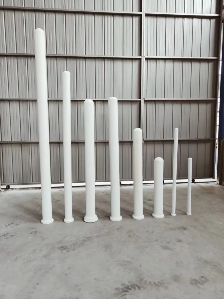 Ceramic fiber filter candle tubes of different diameters standing in a factory workshop