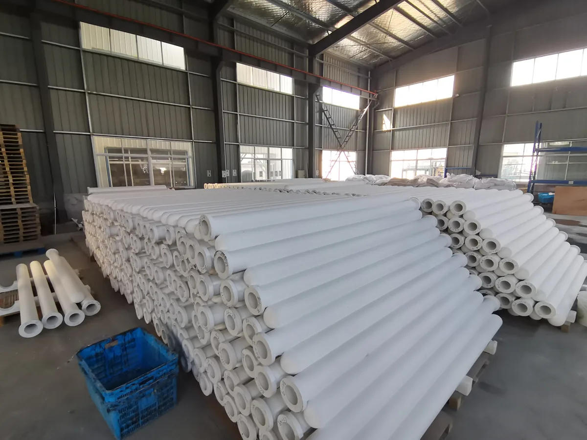 Stacked ceramic fiber filter tubes in a warehouse awaiting commissioning