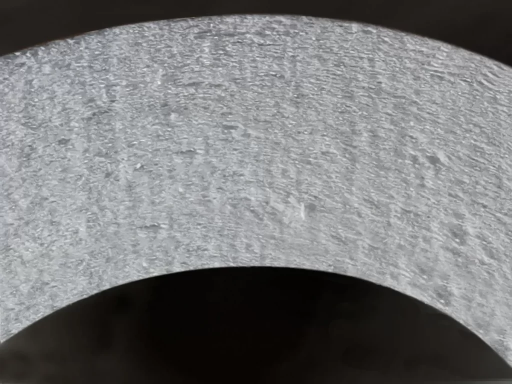 Cross-section of a catalytic ceramic filter wall showing the catalyst-loaded fiber structure