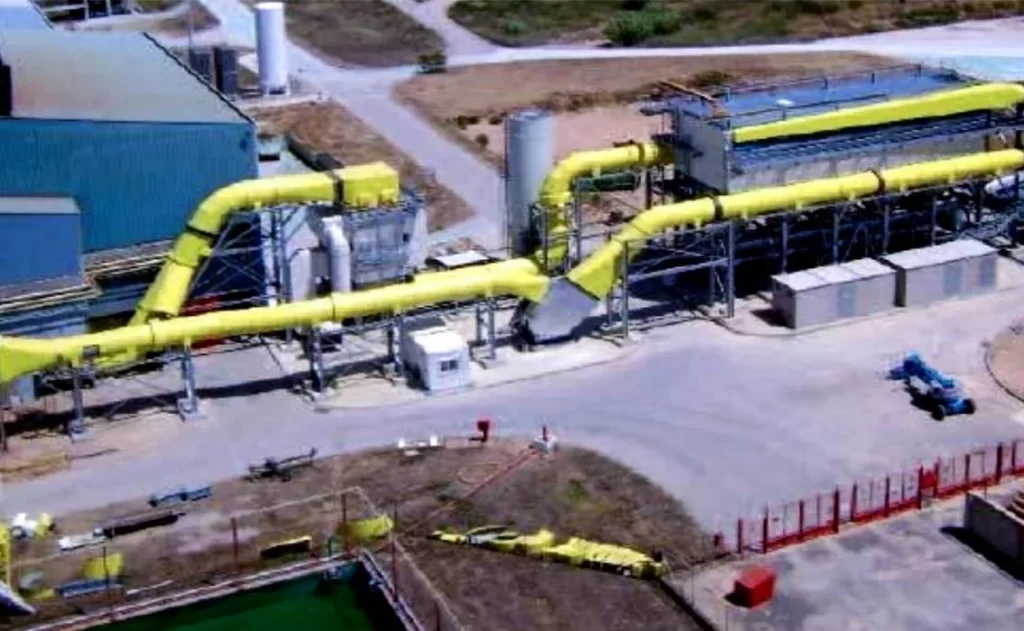 Conventional SCR and scrubber train occupying a large footprint at an industrial plant