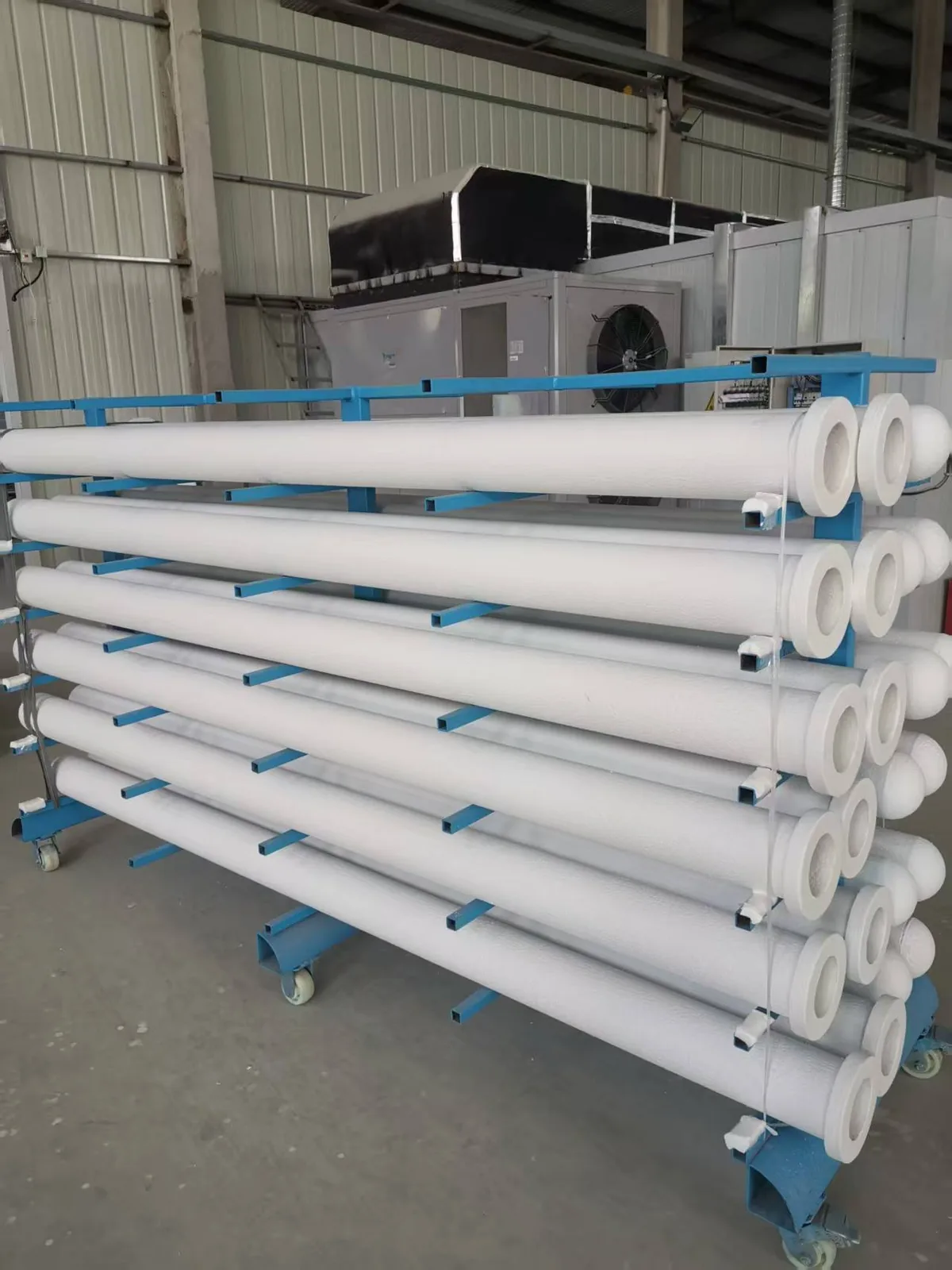 Fresh ceramic filter tubes unwrapped and stacked before pre-coating