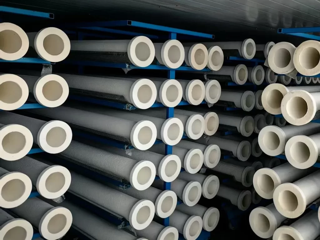 Rows of ceramic fiber filter tubes on storage racks in the production hall